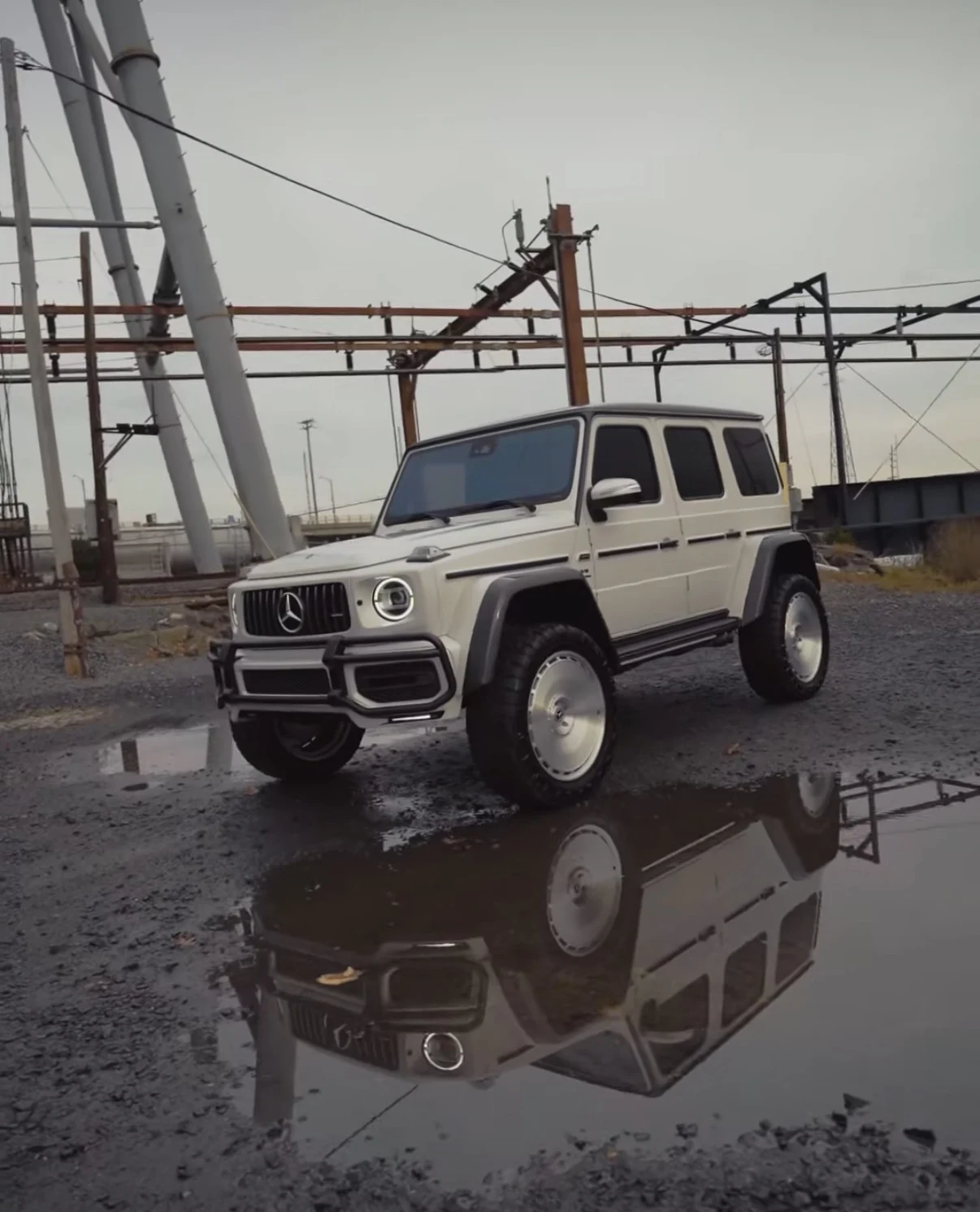 Recent LUX BRABUS project reflected in water at an industrial yard